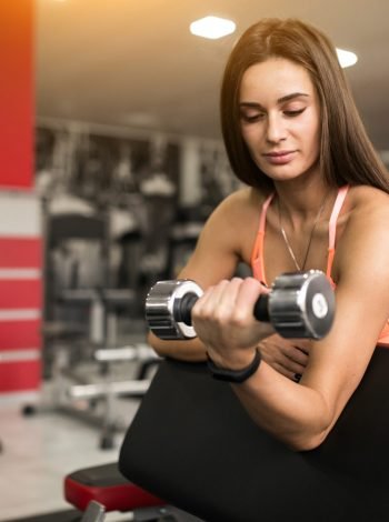 Woman at gym body building