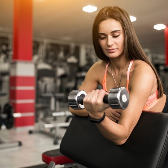 Woman at gym body building